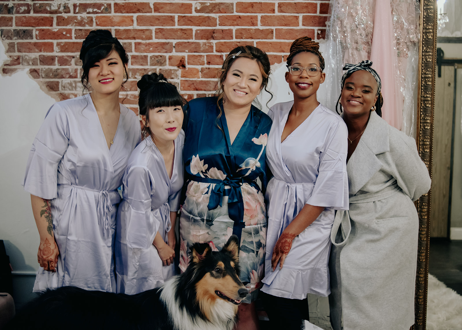 A group of young women and a long-haired dog dressed in silk robes, getting ready for an event.