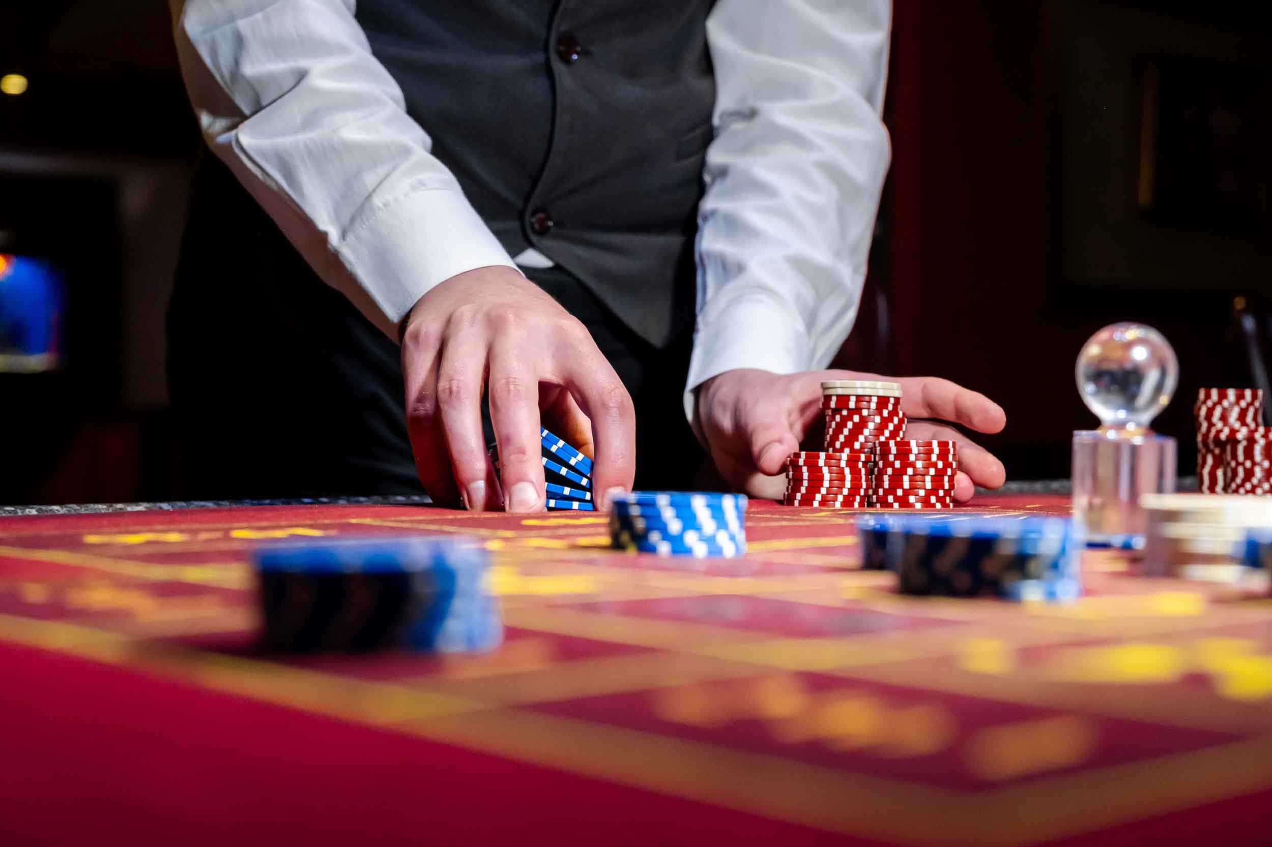 A man places a bet with chips in a casino.