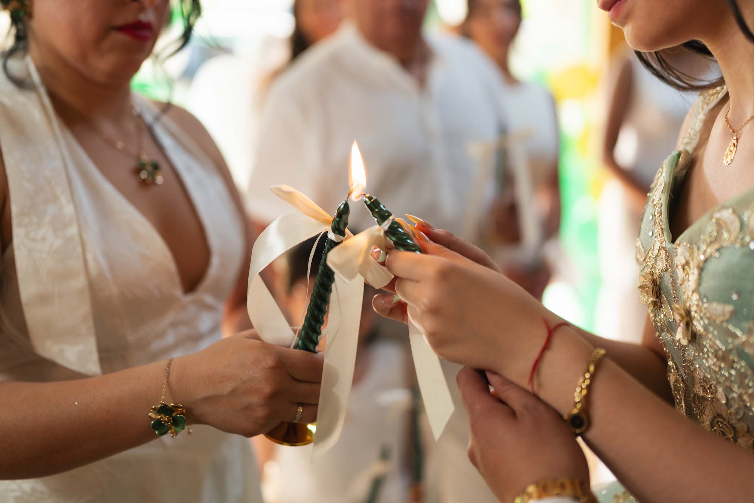 Close up of hands lighting a symbolic candle during a quinceanera ceremony